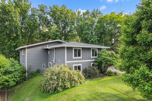 708 Brigadoon Cir, Shoreview, MN 55126 - view of side of home featuring a lawn and board and batten siding