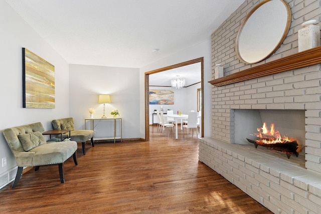 708 Brigadoon Cir, Shoreview, MN 55126 - sitting room featuring wood finished floors, a chandelier, a fireplace, and baseboards