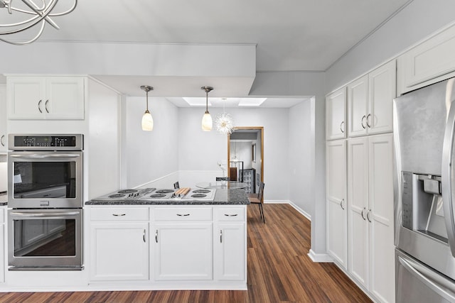 708 Brigadoon Cir, Shoreview, MN 55126 - kitchen with appliances with stainless steel finishes, white cabinetry, dark wood-style floors, and pendant lighting