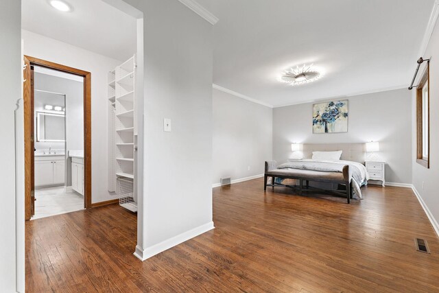 708 Brigadoon Cir, Shoreview, MN 55126 - bedroom featuring wood finished floors, a sink, baseboards, crown molding, and ensuite bathroom