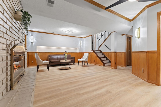 708 Brigadoon Cir, Shoreview, MN 55126 - sitting room featuring ornamental molding, wood finished floors, a textured ceiling, a wainscoted wall, and stairway