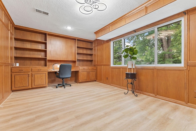 708 Brigadoon Cir, Shoreview, MN 55126 - unfurnished office featuring built in study area, light wood-type flooring, a textured ceiling, wood walls, and ornamental molding