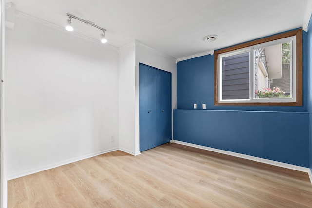 708 Brigadoon Cir, Shoreview, MN 55126 - spare room with wood finished floors, rail lighting, crown molding, and baseboards