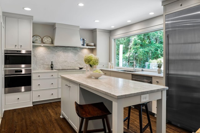 1824 Oliver Ave S, Minneapolis, MN 55405 - kitchen featuring open shelves, appliances with stainless steel finishes, a sink, a kitchen breakfast bar, and recessed lighting