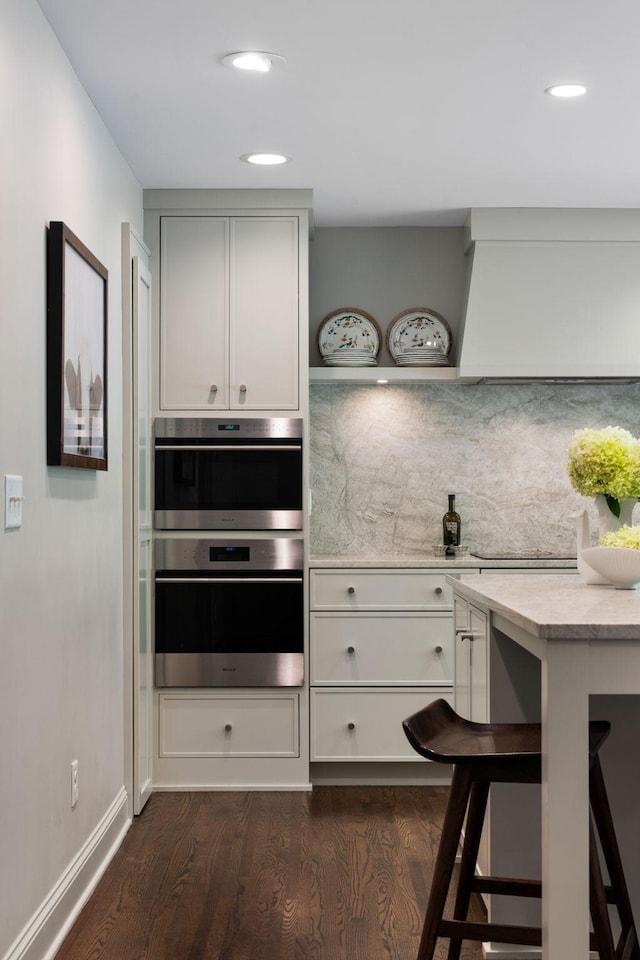 1824 Oliver Ave S, Minneapolis, MN 55405 - kitchen with dark wood finished floors, light countertops, baseboards, recessed lighting, and double oven