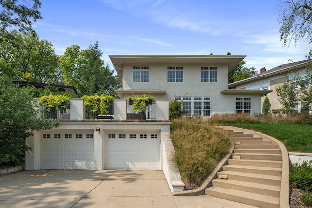 1824 Oliver Ave S, Minneapolis, MN 55405 - view of front of house with stucco siding, driveway, and a balcony