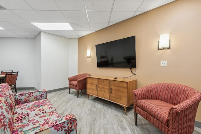 1425 28th St Unit 519, Minneapolis, MN 55408 - living area featuring light wood finished floors, a drop ceiling, and baseboards