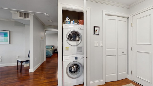 1425 28th St Unit 519, Minneapolis, MN 55408 - laundry room featuring estacked washer and dryer, wood finished floors, crown molding, and baseboards
