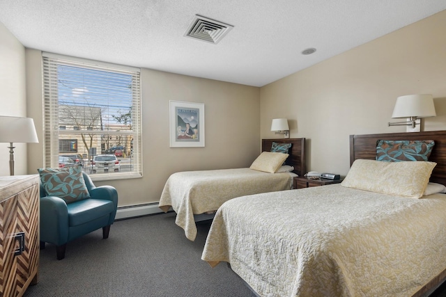 1425 28th St Unit 519, Minneapolis, MN 55408 - bedroom with carpet, a baseboard radiator, and a textured ceiling