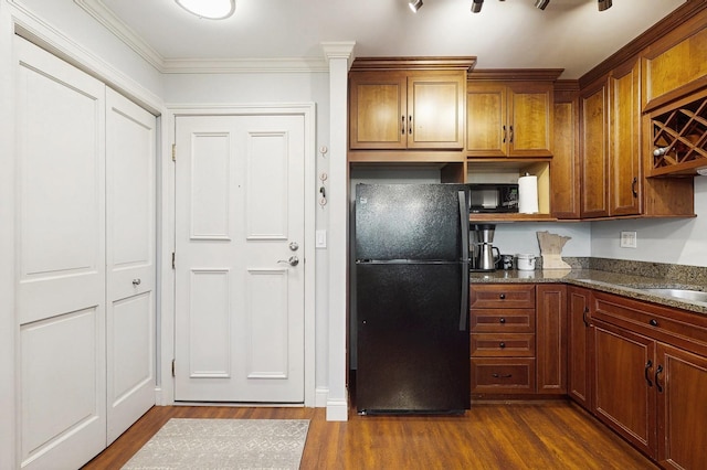 1425 28th St Unit 519, Minneapolis, MN 55408 - kitchen featuring black appliances, dark wood-style floors, brown cabinetry, and crown molding