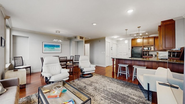 1425 28th St Unit 519, Minneapolis, MN 55408 - living area featuring baseboards, ornamental molding, recessed lighting, and dark wood finished floors