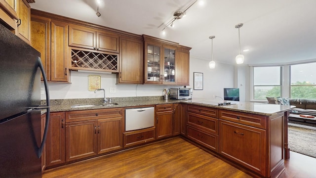 1425 28th St Unit 519, Minneapolis, MN 55408 - kitchen featuring freestanding refrigerator, a sink, dishwasher, a peninsula, and dark stone counters