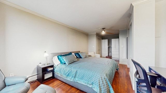 1425 28th St Unit 519, Minneapolis, MN 55408 - bedroom with wood finished floors, a baseboard heating unit, crown molding, and baseboards
