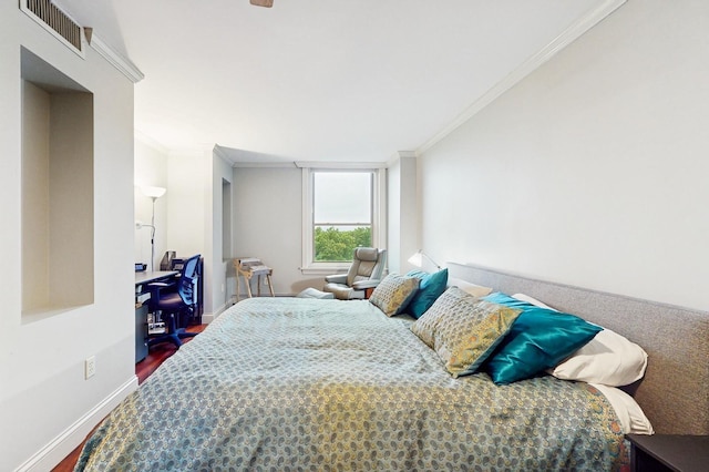 1425 28th St Unit 519, Minneapolis, MN 55408 - bedroom with ornamental molding, wood finished floors, and baseboards