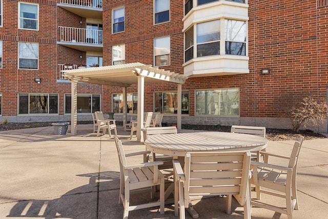 1425 28th St Unit 519, Minneapolis, MN 55408 - view of patio with outdoor dining area and a pergola