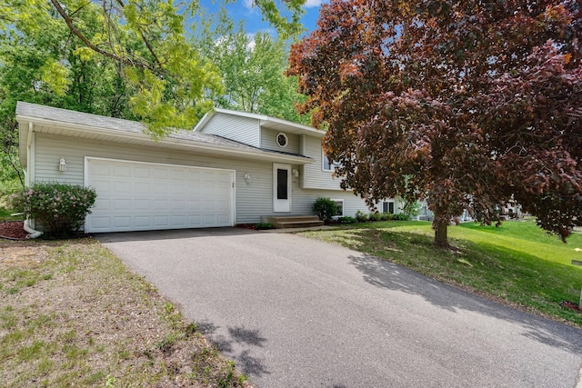 109 Robert Rd, Jordan, MN 55352 - split level home with asphalt driveway, an attached garage, and a front yard