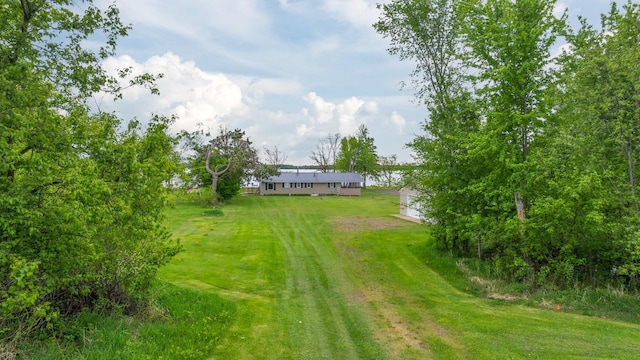 692 Round Lake Ln, Georgetown Twp, WI 54853 - view of green lawn featuring an outdoor structure and a garage