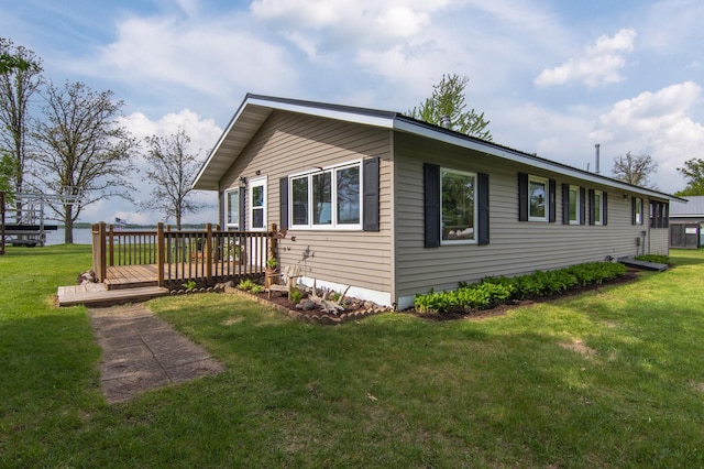 692 Round Lake Ln, Georgetown Twp, WI 54853 - view of home's exterior featuring a wooden deck and a yard