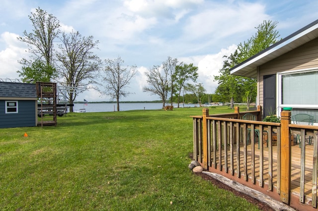 692 Round Lake Ln, Georgetown Twp, WI 54853 - view of grassy yard featuring a deck with water view