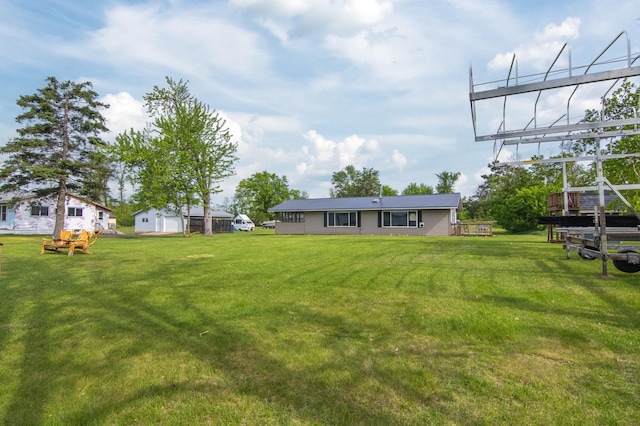 692 Round Lake Ln, Georgetown Twp, WI 54853 - view of green lawn with a deck