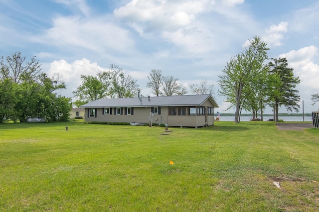 692 Round Lake Ln, Georgetown Twp, WI 54853 - view of front of house with a front yard, a water view, and metal roof