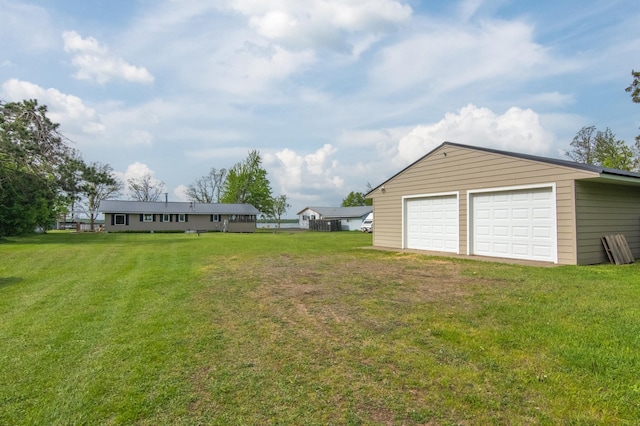692 Round Lake Ln, Georgetown Twp, WI 54853 - view of grassy yard featuring a garage and an outbuilding