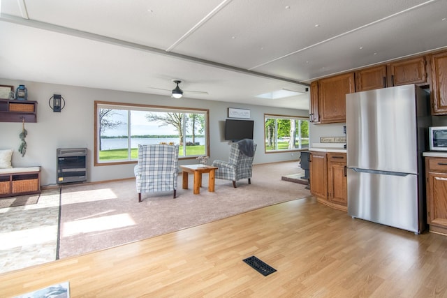 692 Round Lake Ln, Georgetown Twp, WI 54853 - living area with light wood-style floors, ceiling fan, and heating unit