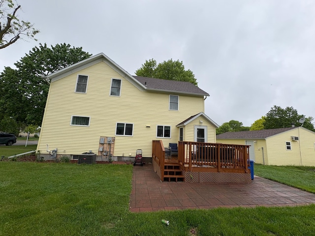 809 14th St S, Benson, MN 56215 - back of house featuring a lawn, a deck, cooling unit, and a patio