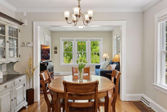 4034 Nokomis Ave, Minneapolis, MN 55406 - dining space with light wood-style floors, healthy amount of natural light, a chandelier, baseboards, and ornamental molding