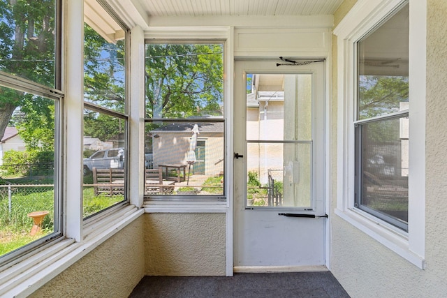 4034 Nokomis Ave, Minneapolis, MN 55406 - unfurnished sunroom featuring healthy amount of natural light, a textured wall, and carpet