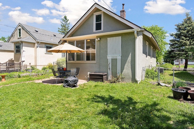 4034 Nokomis Ave, Minneapolis, MN 55406 - back of property with stucco siding, a chimney, and a patio area