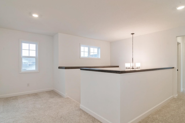 bar featuring healthy amount of natural light, carpet flooring, baseboards, a chandelier, and recessed lighting