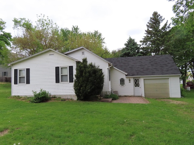 114 2nd St S, Truman, MN 56088 - rear view of house with a garage and a yard
