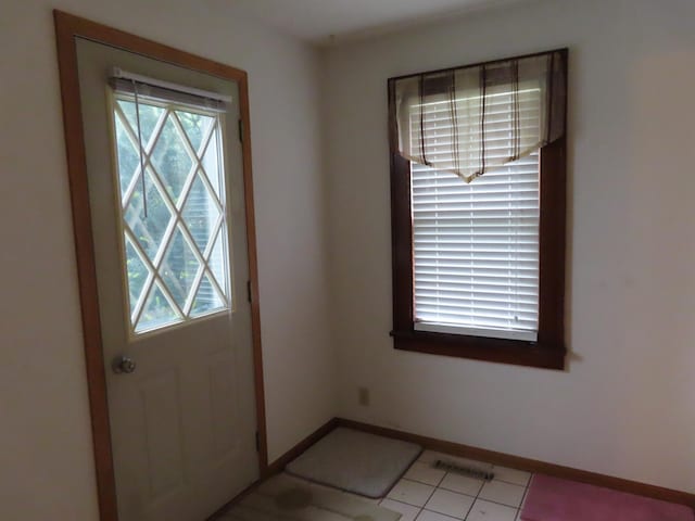 114 2nd St S, Truman, MN 56088 - entryway with baseboards and light tile patterned floors