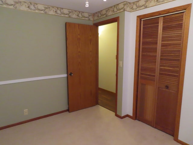 114 2nd St S, Truman, MN 56088 - unfurnished bedroom featuring light colored carpet, a closet, and baseboards
