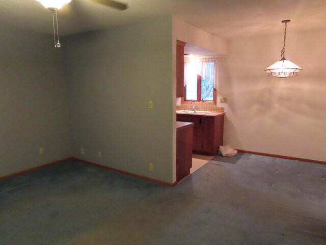 114 2nd St S, Truman, MN 56088 - unfurnished dining area with a sink, baseboards, light colored carpet, and a ceiling fan
