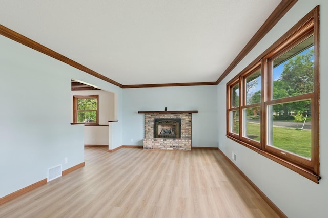 2197 Beam Ave, Maplewood, MN 55109 - unfurnished living room with light wood-style floors, crown molding, baseboards, and a brick fireplace