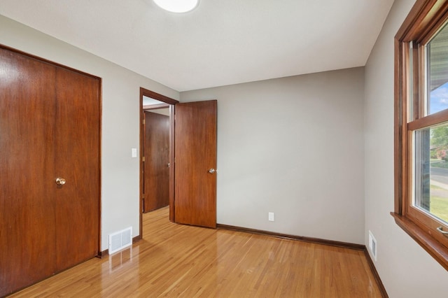 2197 Beam Ave, Maplewood, MN 55109 - unfurnished bedroom featuring light wood-style flooring and baseboards
