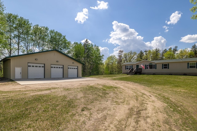 58885 County Road 136, Menahga, MN 56464 - view of front facade with a detached garage, an outdoor structure, a front lawn, and dirt driveway