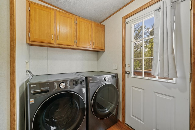 58885 County Road 136, Menahga, MN 56464 - laundry room featuring washer and dryer, cabinet space, and a textured ceiling