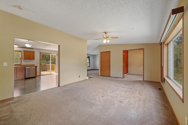 58885 County Road 136, Menahga, MN 56464 - unfurnished living room featuring light colored carpet, a textured ceiling, ceiling fan, and baseboards