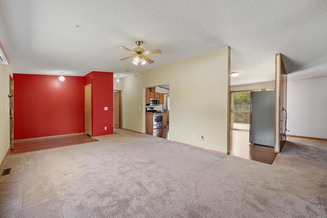 58885 County Road 136, Menahga, MN 56464 - unfurnished living room featuring carpet, a ceiling fan, a textured ceiling, and baseboards
