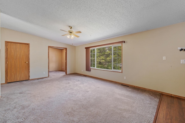 58885 County Road 136, Menahga, MN 56464 - unfurnished bedroom with baseboards, a textured ceiling, ceiling fan, and carpet flooring
