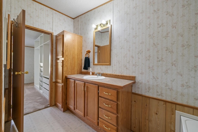 58885 County Road 136, Menahga, MN 56464 - bathroom with crown molding, wallpapered walls, vanity, a bath, and a textured ceiling