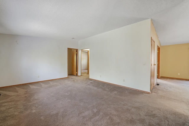 58885 County Road 136, Menahga, MN 56464 - spare room featuring a textured ceiling, light carpet, and baseboards