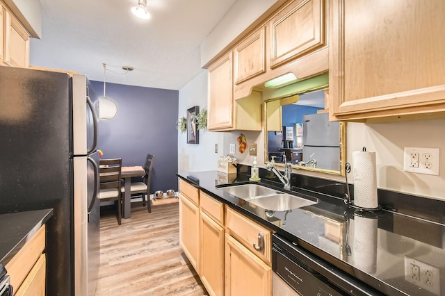2727 43rd St Unit 102, Minneapolis, MN 55410 - kitchen with freestanding refrigerator, a sink, light brown cabinetry, dark countertops, and light wood-type flooring