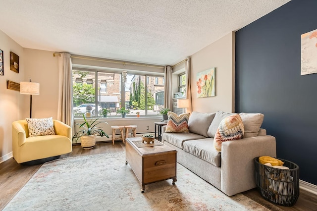 2727 43rd St Unit 102, Minneapolis, MN 55410 - living area with wood finished floors, a textured ceiling, and baseboards