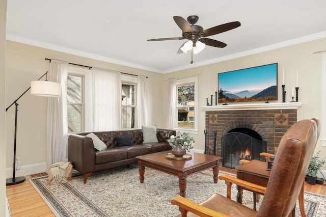 1750 Sims Ave, Saint Paul, MN 55106 - living area with a ceiling fan, wood finished floors, baseboards, a brick fireplace, and ornamental molding