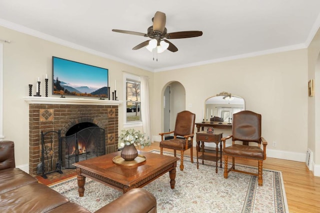 1750 Sims Ave, Saint Paul, MN 55106 - living area featuring wood finished floors, baseboards, a ceiling fan, ornamental molding, and a fireplace