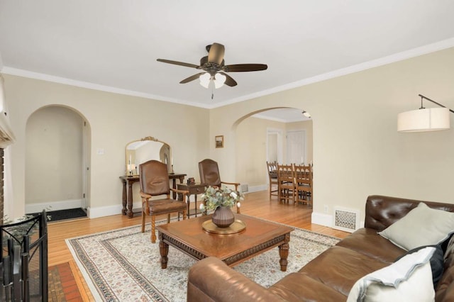 1750 Sims Ave, Saint Paul, MN 55106 - living area featuring arched walkways, ceiling fan, wood finished floors, baseboards, and ornamental molding